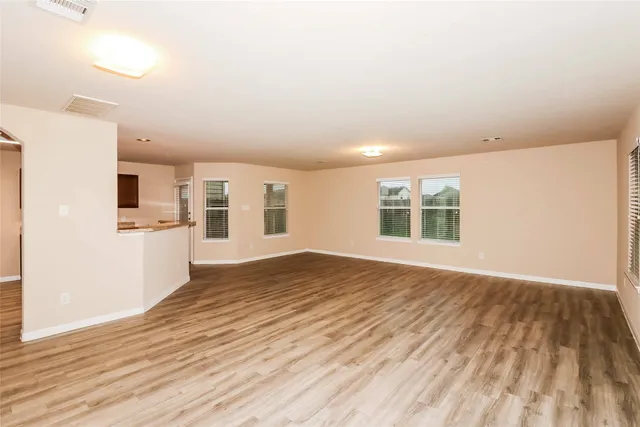 a view of a kitchen with wooden floor and a sink