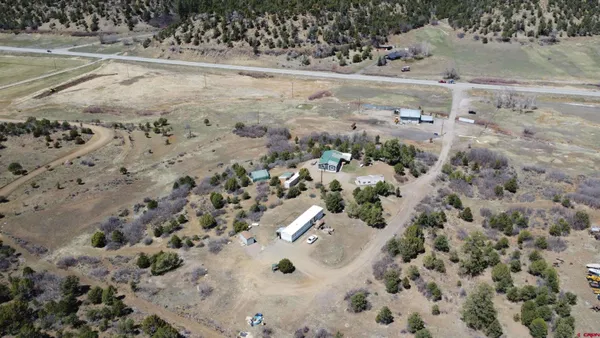an aerial view of beach and residential houses with outdoor space