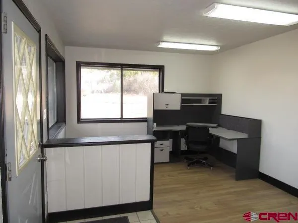 a view of a room with wooden floor and cabinet