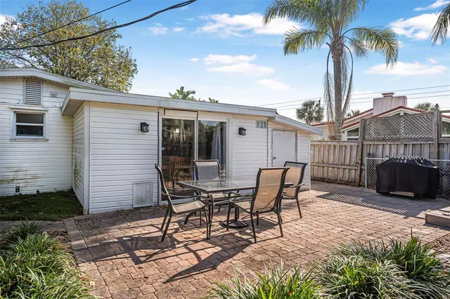 a view of a backyard with sitting area