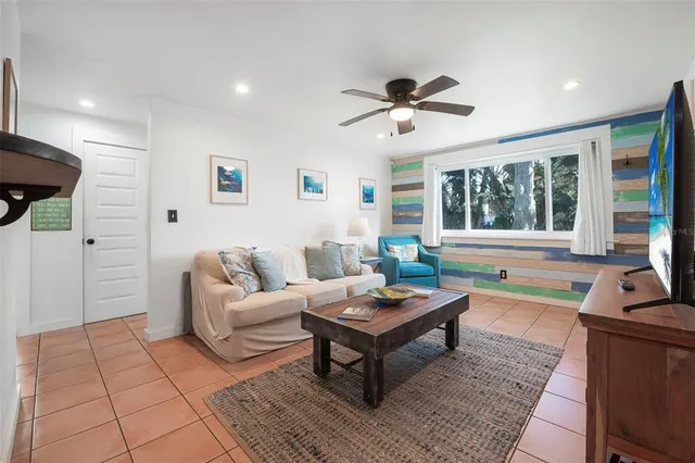 a living room with furniture and kitchen view