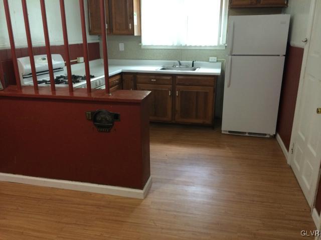 446 West Gordon Street Allentown, PA 18102 - Photo 3 of 9 a kitchen with a sink a refrigerator freezer a stove and a window