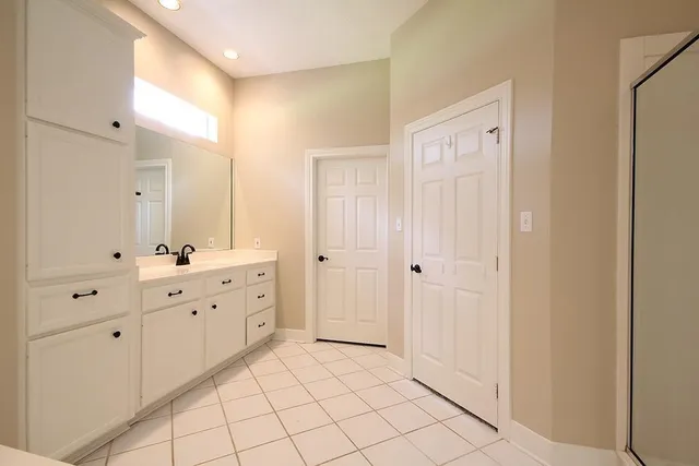 a spacious bathroom with a double vanity sink mirror and
