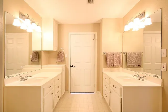 a bathroom with a sink a mirror and a shower