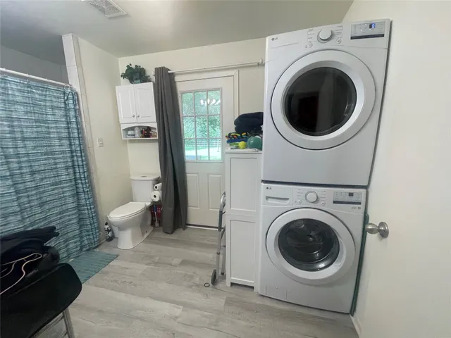 a view of a hallway with washer and dryer