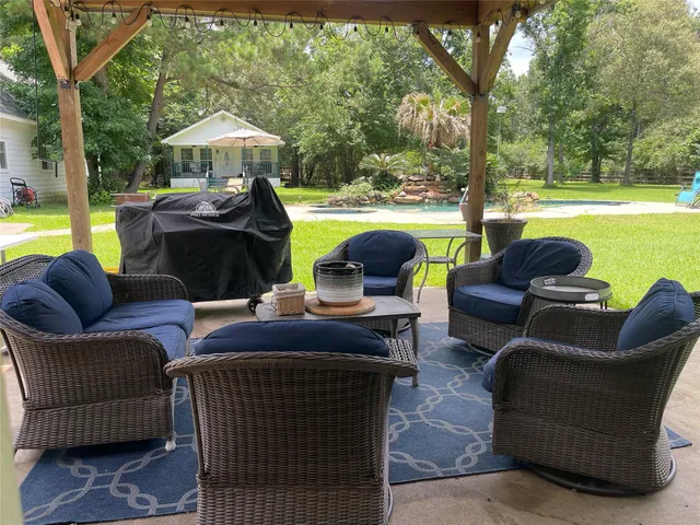 a view of a patio with couches chairs and a potted plant