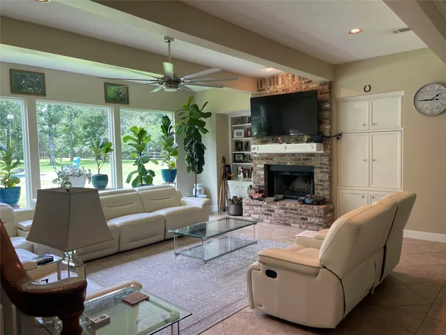 a living room with furniture a flat screen tv and a fireplace