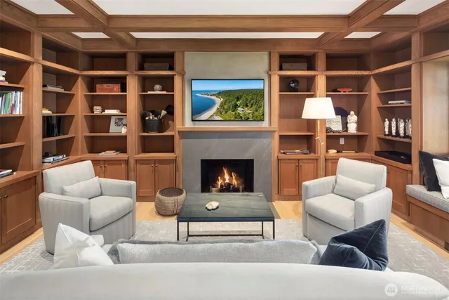 a living room with furniture a rug and a fireplace