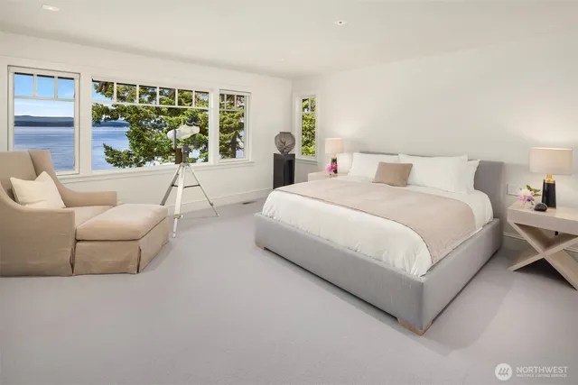 a bedroom with a bed and a large window