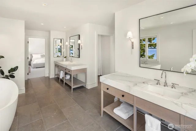 a spacious bathroom with a sink a mirror and a bathtub