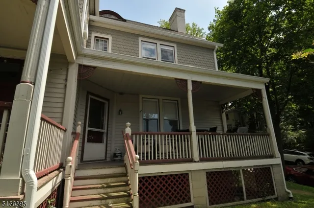 a view of a brick house with a deck