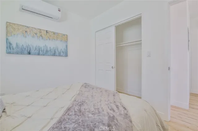 a bedroom with a bed and a wall painting