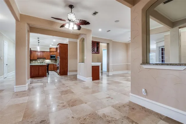 a kitchen with stainless steel appliances granite countertop wooden cabinets a refrigerator and a sink