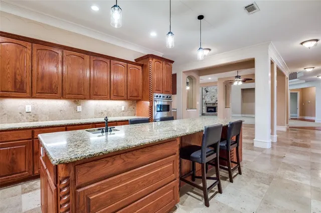 a kitchen with granite countertop wooden cabinets a sink and dishwasher