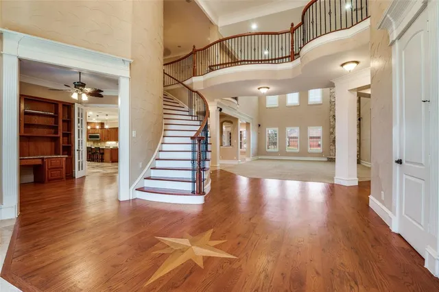 a view of a room with wooden floors and stairs