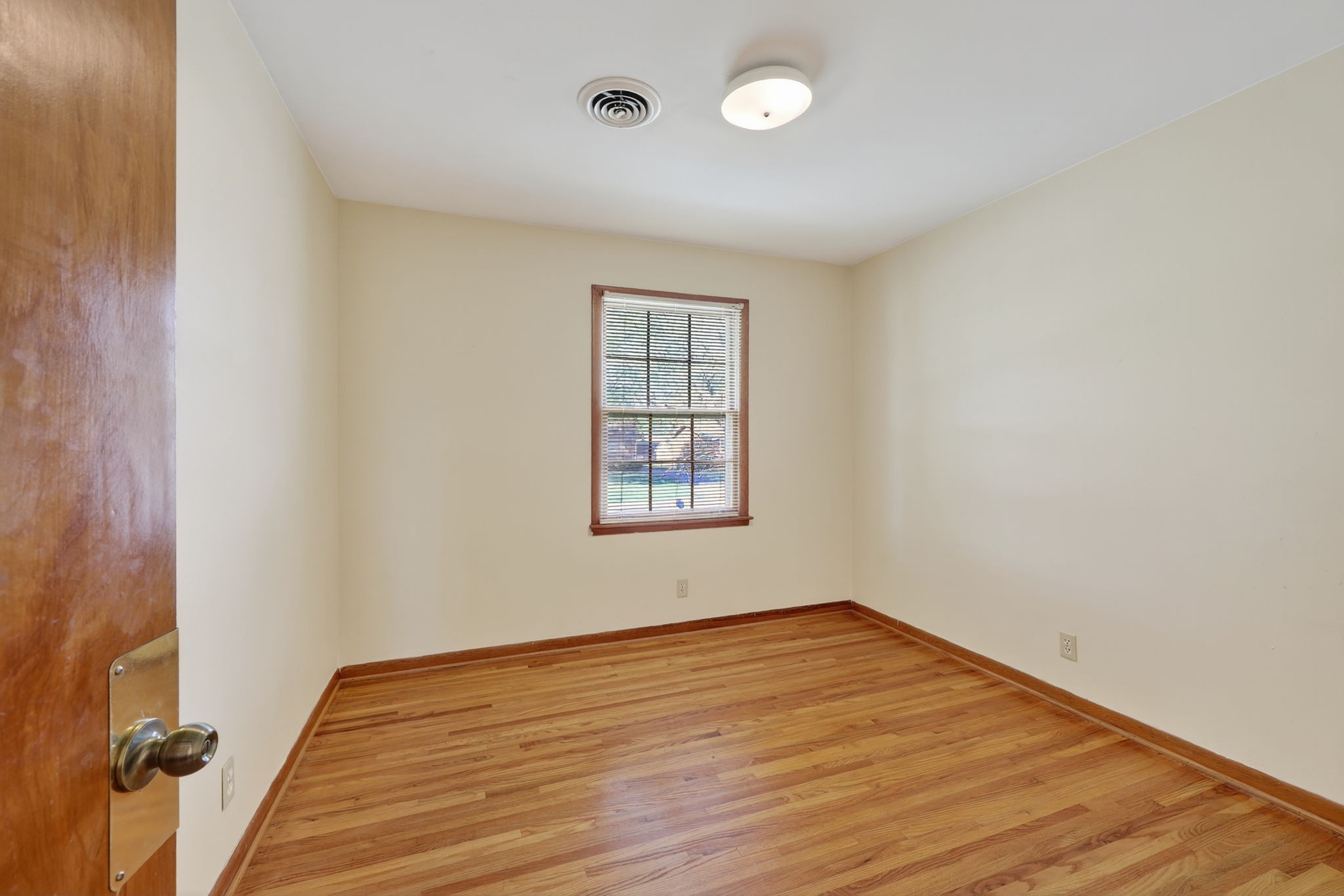103 Fischer Drive Springfield, TN 37172 - Photo 20 of 45 an empty room with wooden floor and windows