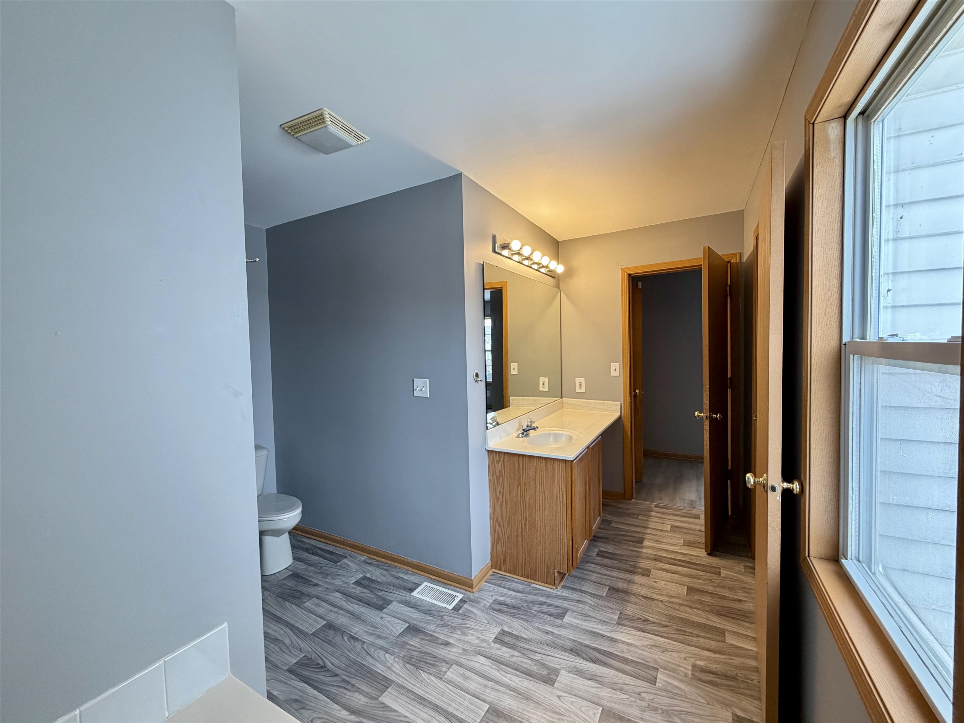 2424 Winfield Lane Belvidere, IL 61008 - Photo 16 of 30 a view of a hallway with wooden floor and staircase