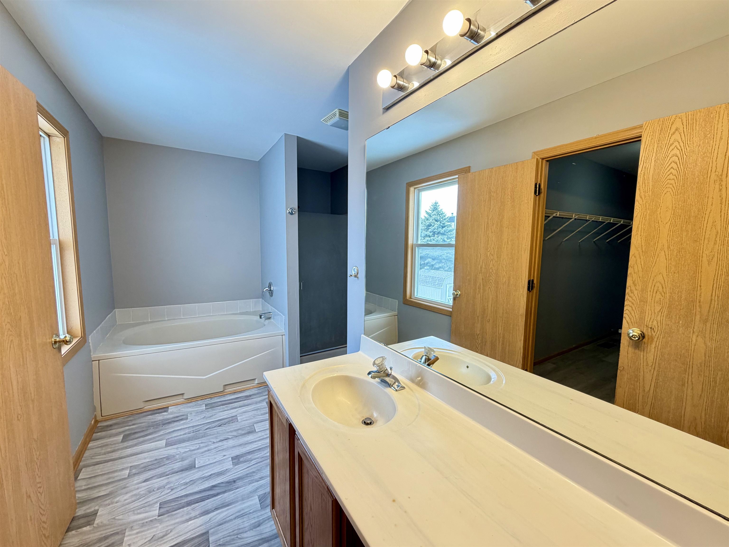 2424 Winfield Lane Belvidere, IL 61008 - Photo 17 of 30 a bathroom with a tub sink and a mirror