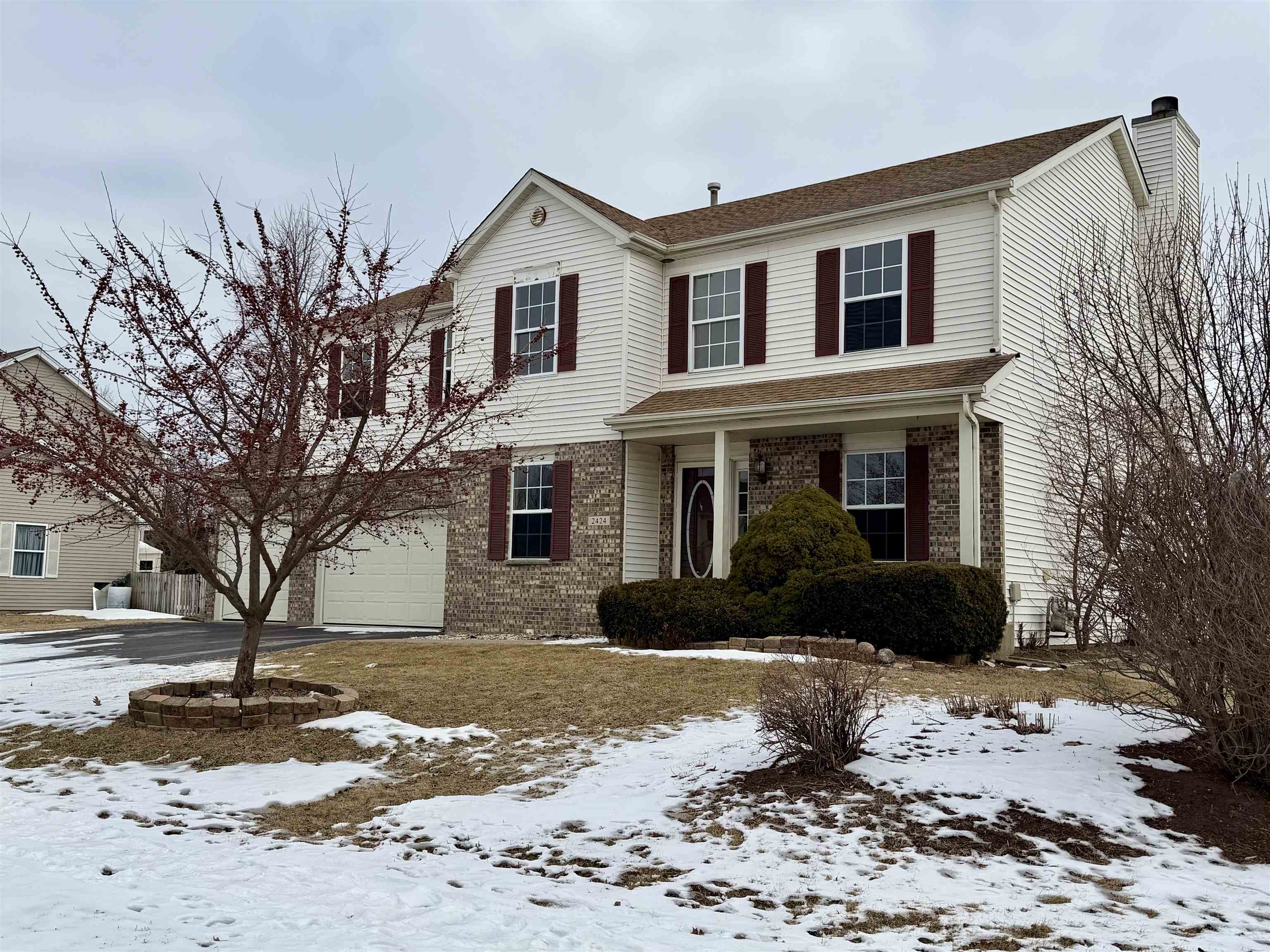 2424 Winfield Lane Belvidere, IL 61008 - Photo 2 of 30 a front view of a house with a yard covered in snow