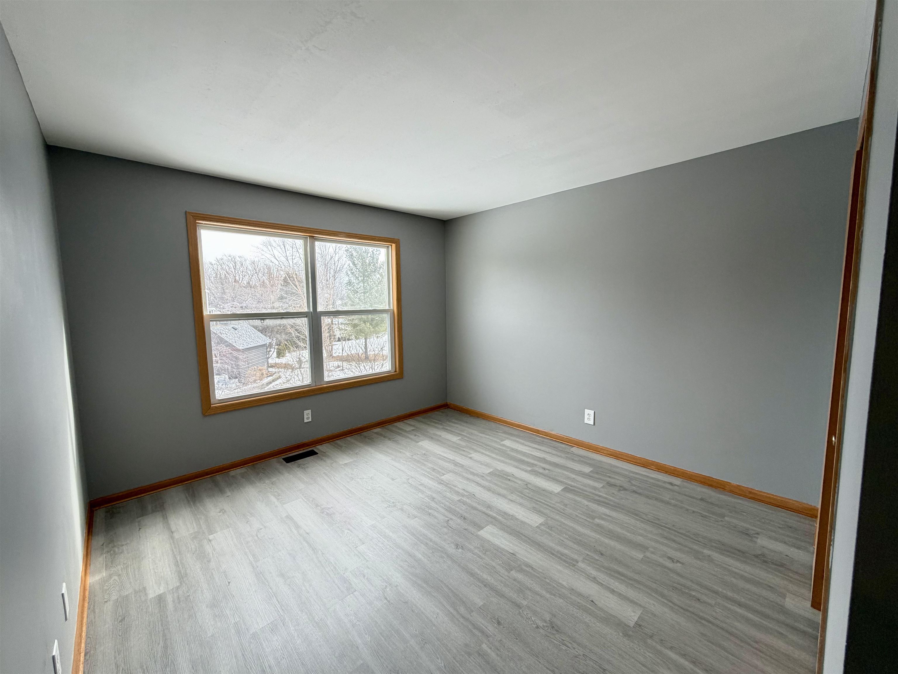 2424 Winfield Lane Belvidere, IL 61008 - Photo 22 of 30 an empty room with wooden floor and windows