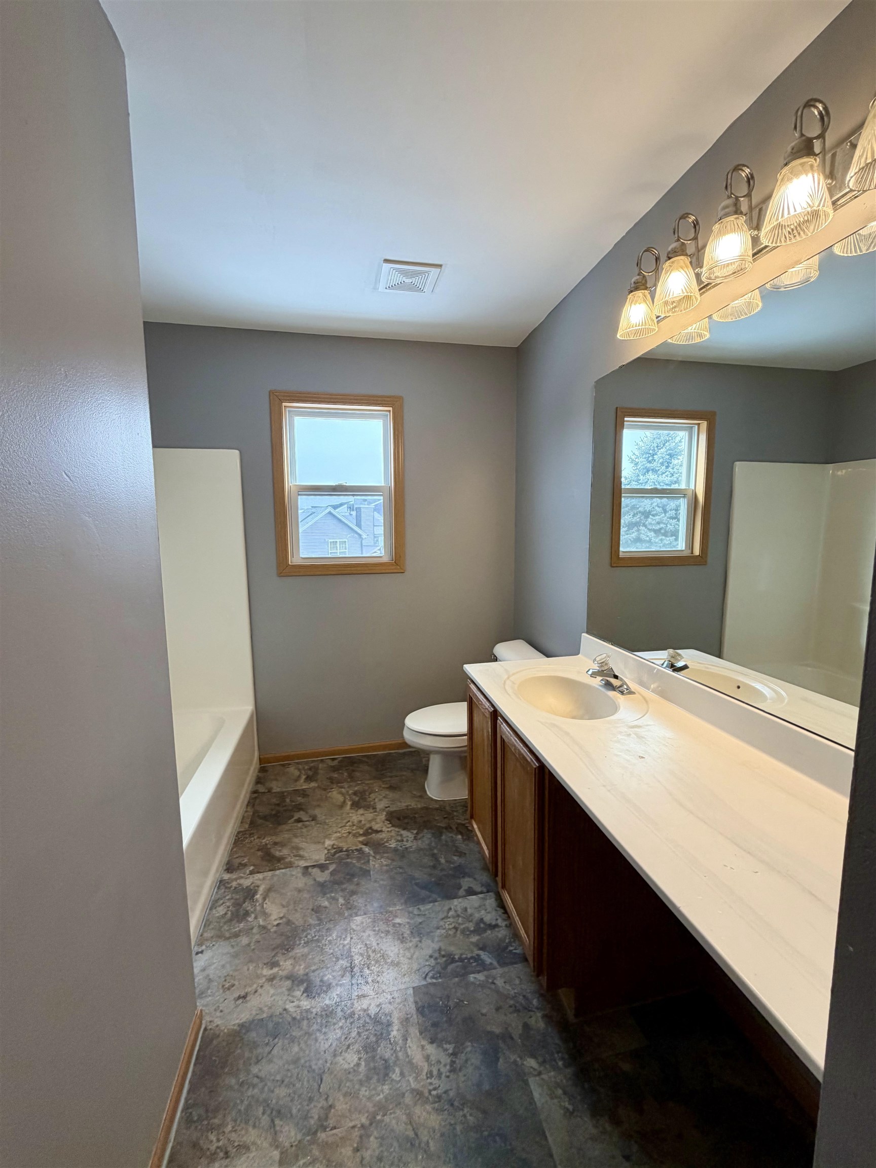 2424 Winfield Lane Belvidere, IL 61008 - Photo 23 of 30 a bathroom with a sink a toilet a mirror and vanity