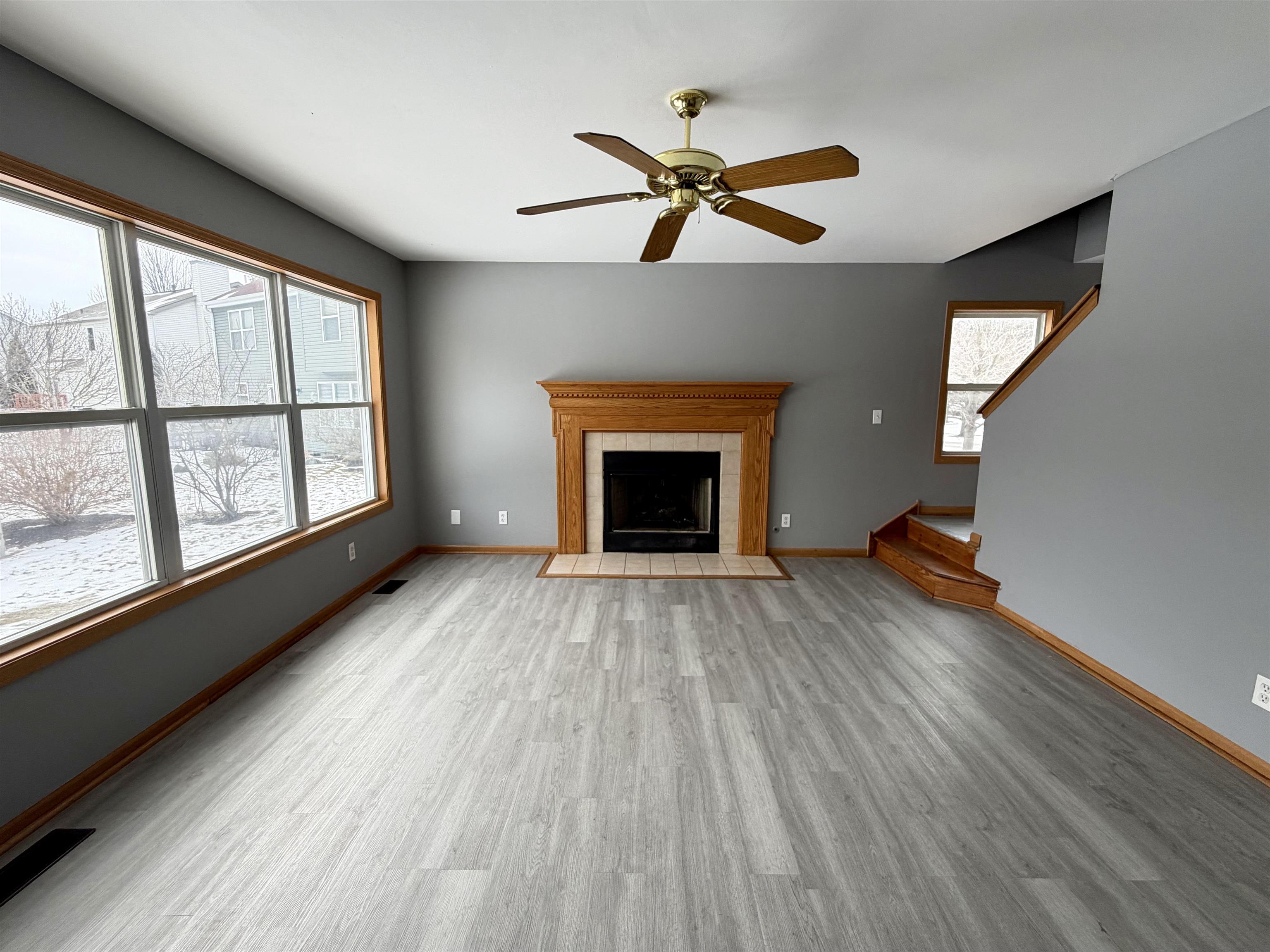 2424 Winfield Lane Belvidere, IL 61008 - Photo 3 of 30 wooden floor fireplace and windows in an empty room