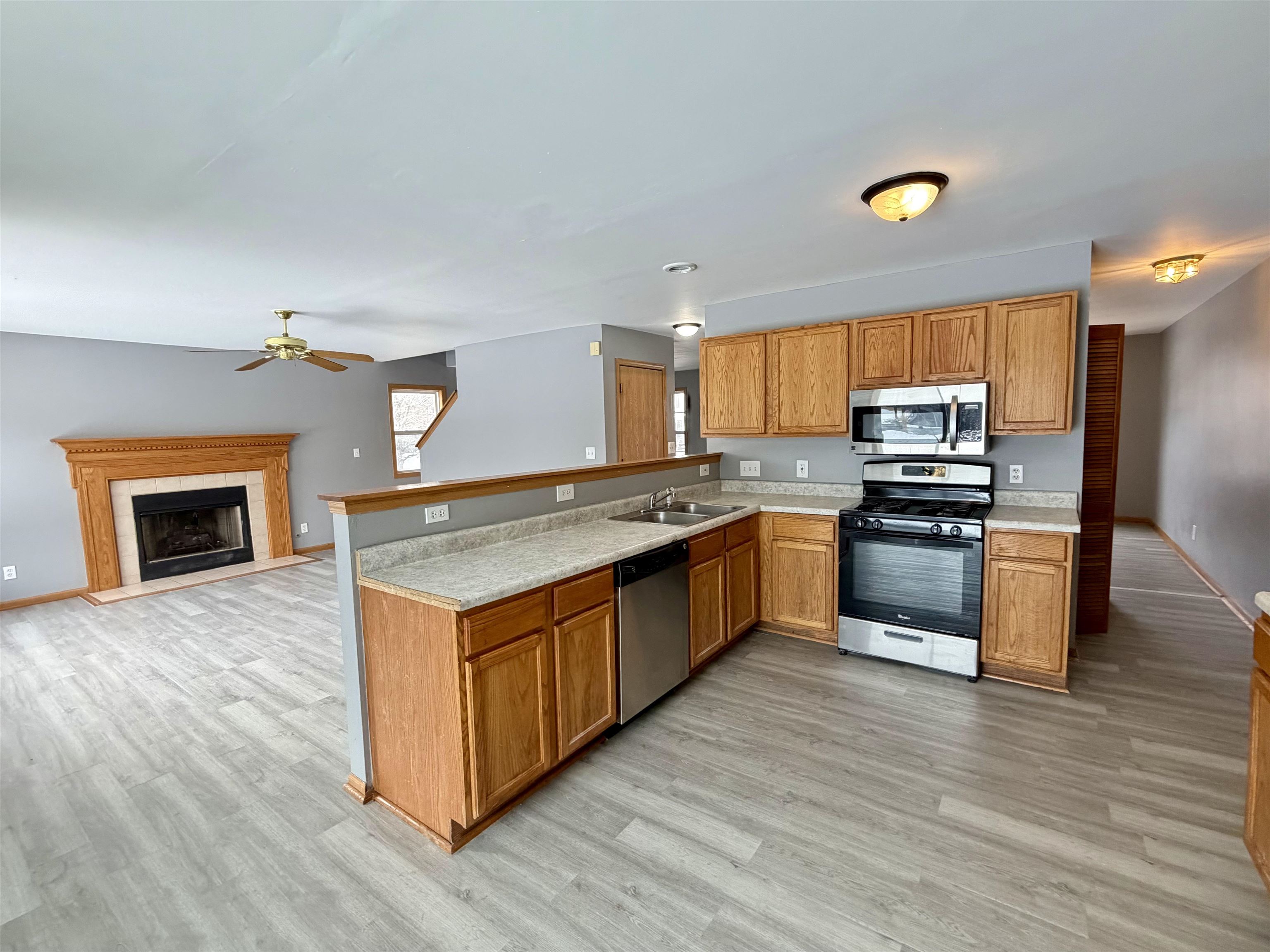 2424 Winfield Lane Belvidere, IL 61008 - Photo 4 of 30 a kitchen with granite countertop a stove top oven and cabinets