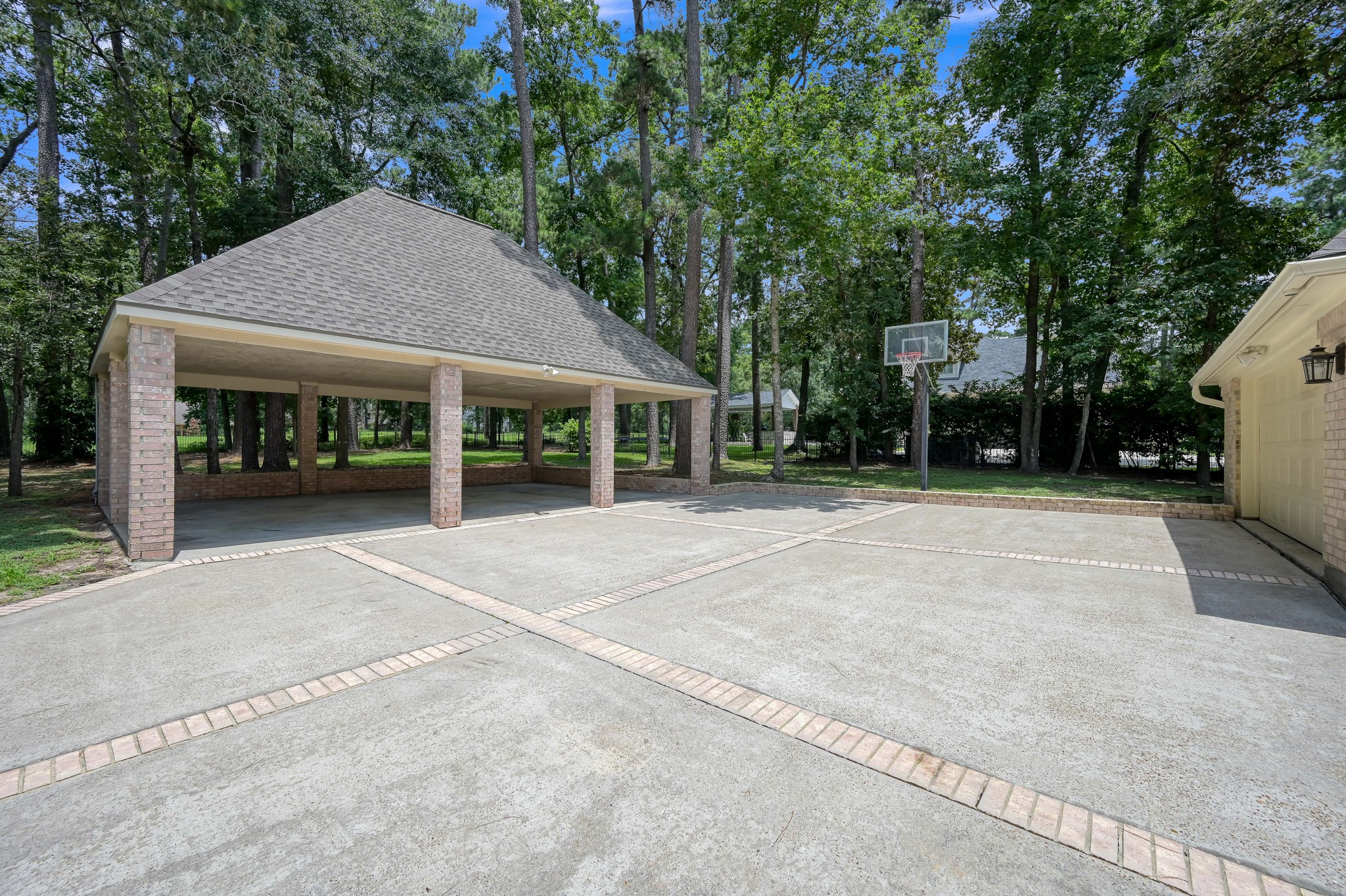 2205 Longmire Road Conroe, TX 77304 - Photo 34 of 49 In addition to a 2 car garage, there is a 3 car covered carport. This would also make the perfect party patio!!