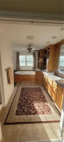 a bathroom with a bathtub and a rug
