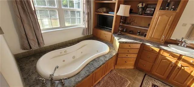 a bathroom with a bathtub and a sink