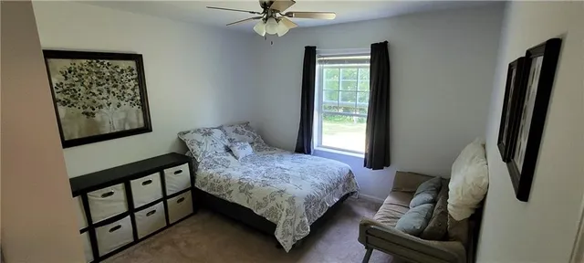 a bedroom with a bed furniture and a window