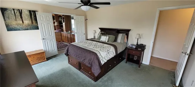 a bedroom with a bed couch and a window