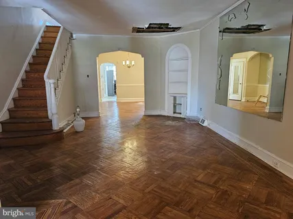 a view of a hallway with entryway wooden floor and front door