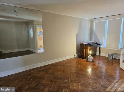 a view of empty room with windows and couch