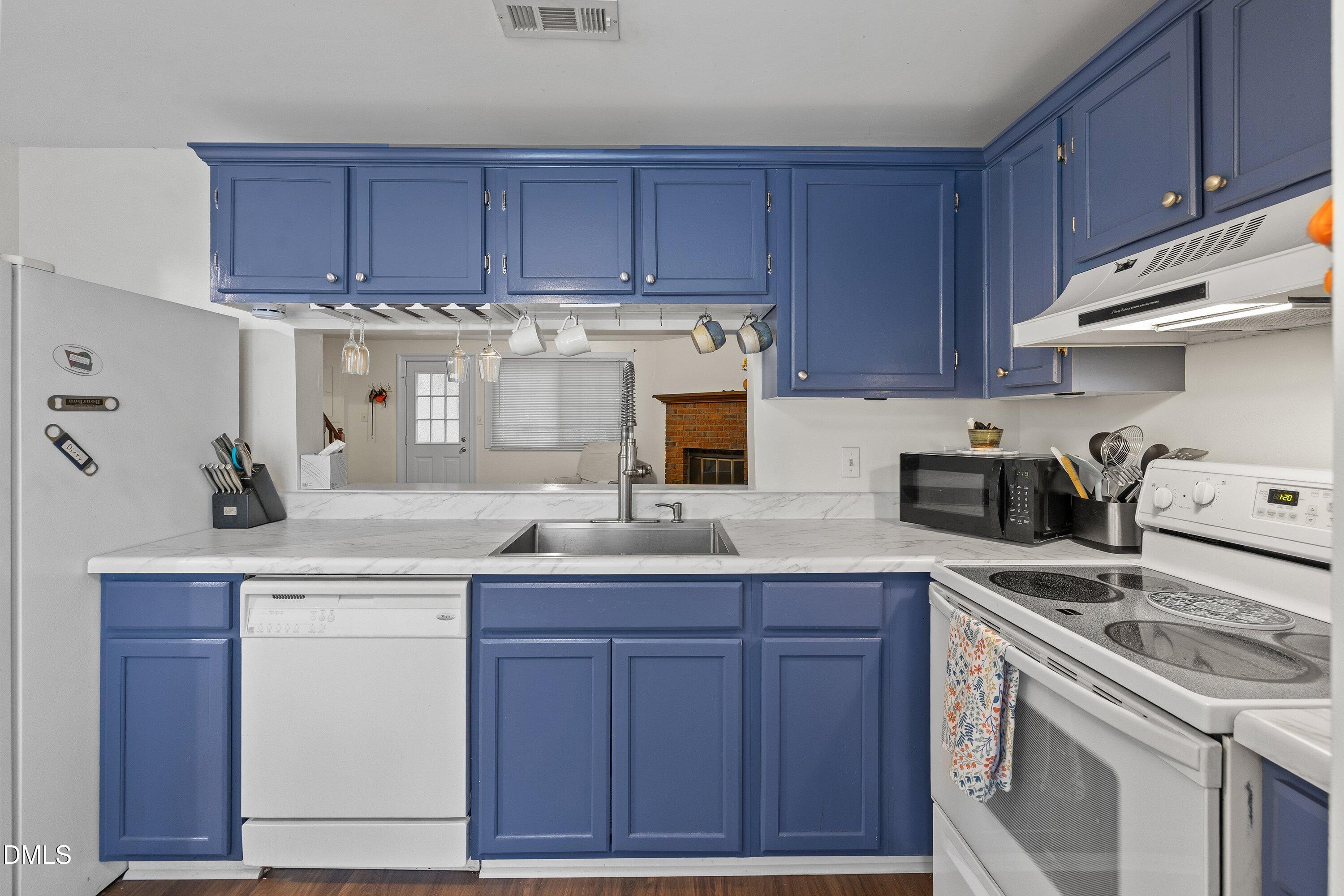 7729 Bernadette Lane Raleigh, NC 27615 - Photo 10 of 34 a kitchen with a sink a stove and cabinets