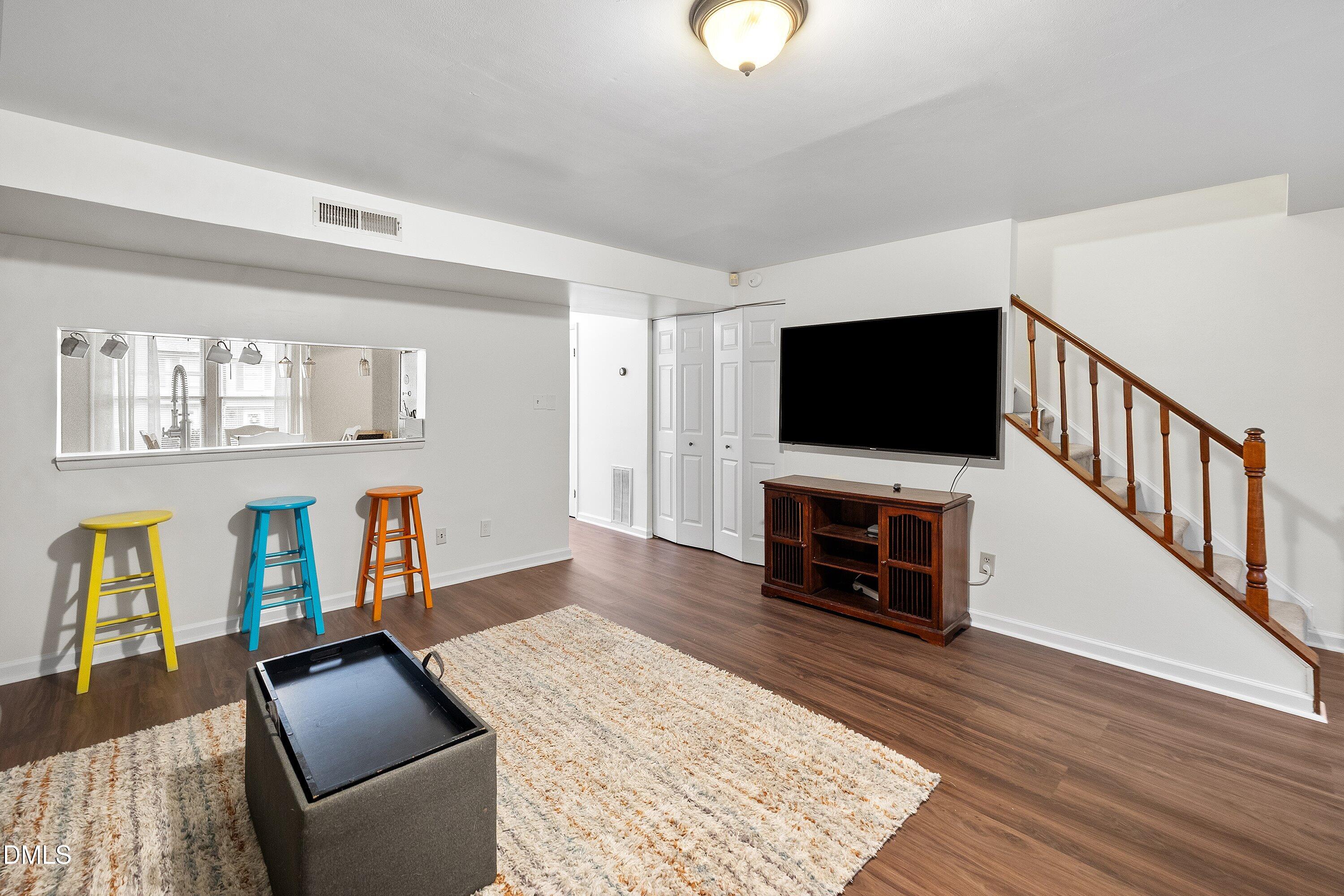 7729 Bernadette Lane Raleigh, NC 27615 - Photo 14 of 34 a living room with furniture and a flat screen tv