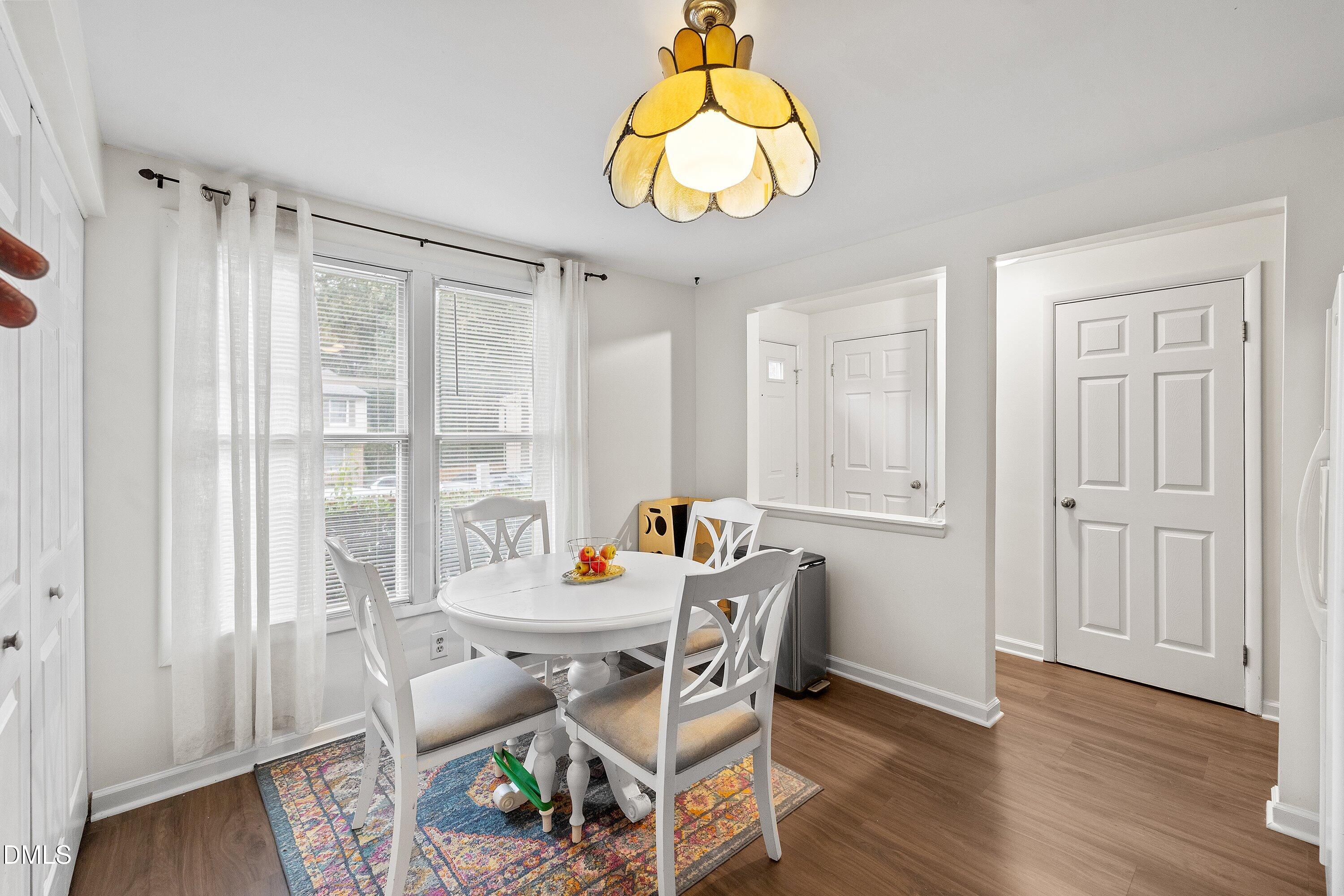7729 Bernadette Lane Raleigh, NC 27615 - Photo 4 of 34 a view of a dining room with furniture window and wooden floor