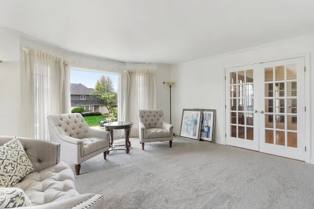 a living room with furniture and large windows