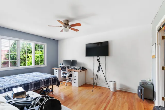 a living room with furniture a flat screen tv and a window