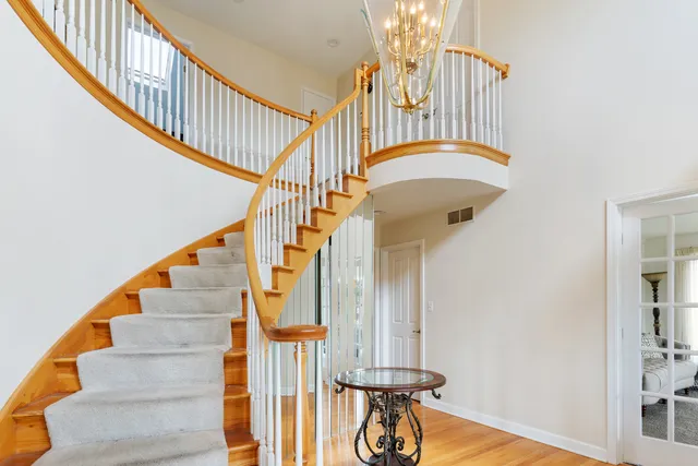 a view of entryway and hall with wooden floor