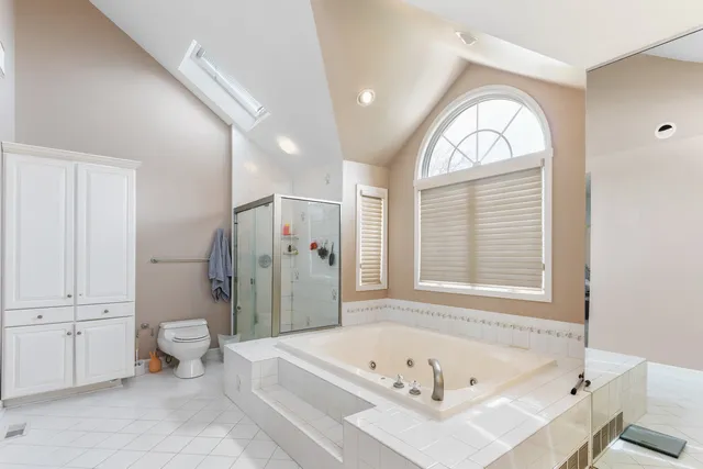 a bathroom with a tub a toilet and a sink