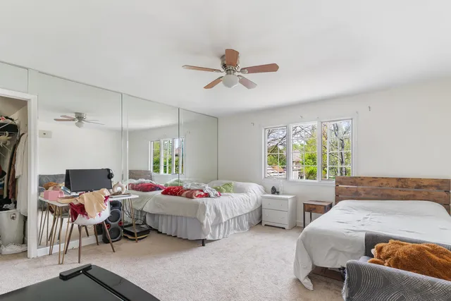 a bedroom with two beds and a window