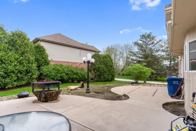 a view of backyard with outdoor seating and plants