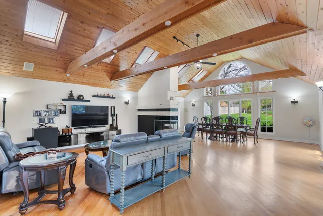 a living room with furniture a fireplace and a table