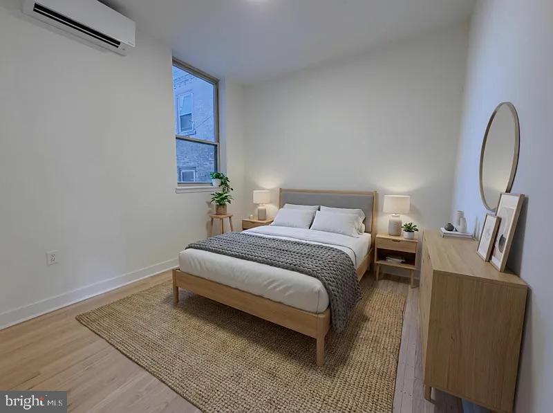 2005 Green Street, Unit 2F Philadelphia, PA 19130 - Photo 2 of 11 a bedroom with a bed a mirror and a night stand