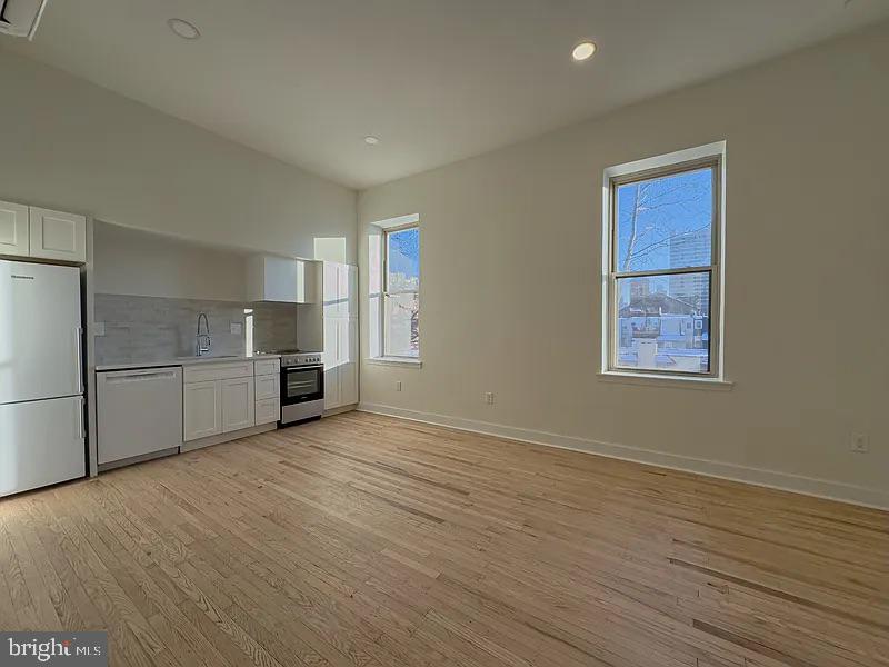 2005 Green Street, Unit 2F Philadelphia, PA 19130 - Photo 6 of 11 a view of kitchen with wooden floor electronic appliances and window
