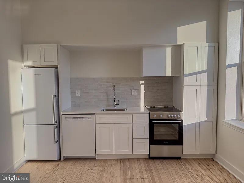 2005 Green Street, Unit 2F Philadelphia, PA 19130 - Photo 7 of 11 a kitchen with cabinets and appliances