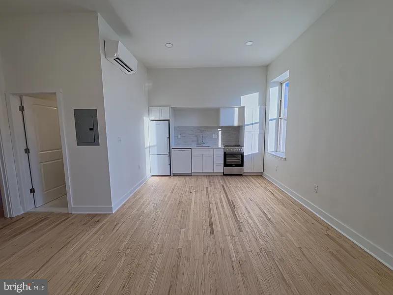 2005 Green Street, Unit 2F Philadelphia, PA 19130 - Photo 8 of 11 a view of empty room with a fireplace and wooden floor