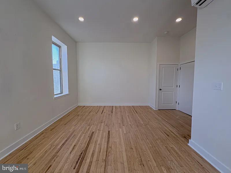 2005 Green Street, Unit 2F Philadelphia, PA 19130 - Photo 10 of 11 a view of an empty room with wooden floor and a window