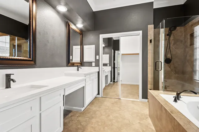 a spacious bathroom with a bathtub shower sink and mirror
